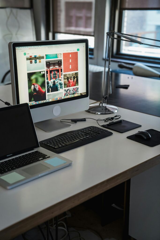 A sleek, modern office desk setup with computers and gadgets, perfect for productivity.
